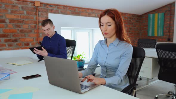 Two Young Employees in Startup Company alt