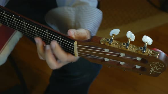 Hand of Male Musician Playing on Acoustic Guitar