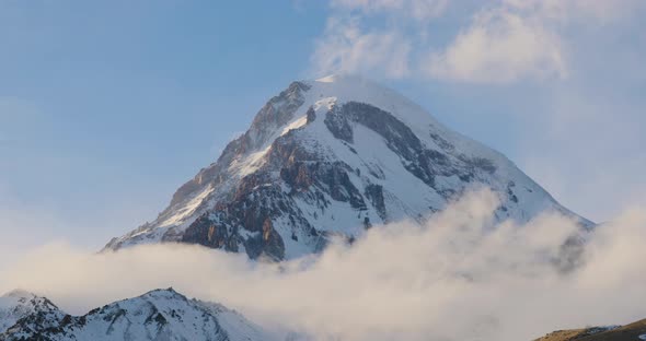 Stepantsminda, Gergeti, Georgia. Peak Of Mount Kazbek Covered Snow In Winter Landscape. alt