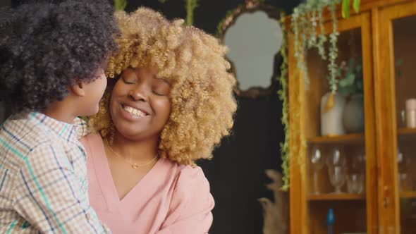 Joyful African American Mother and Son Playing at Home alt