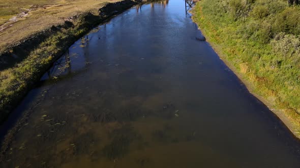 Old train trestle on a sunny day in north American Prairie. Aerial 4K Drone footage revealing scener alt