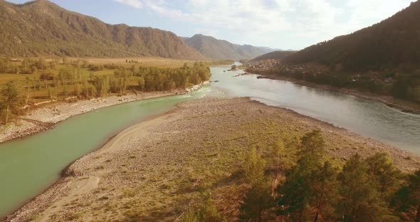 Low Altitude Flight Over Fresh Fast Mountain River with Rocks at Sunny Summer Morning. alt