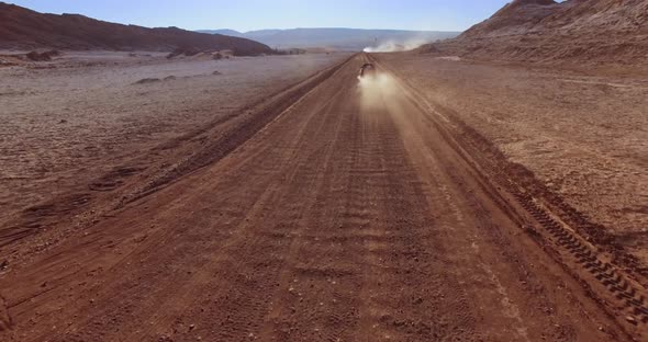 The Fast Aerial Pursuit of the Vehicle in the Moon Valley. Atacama Desert, Chile alt