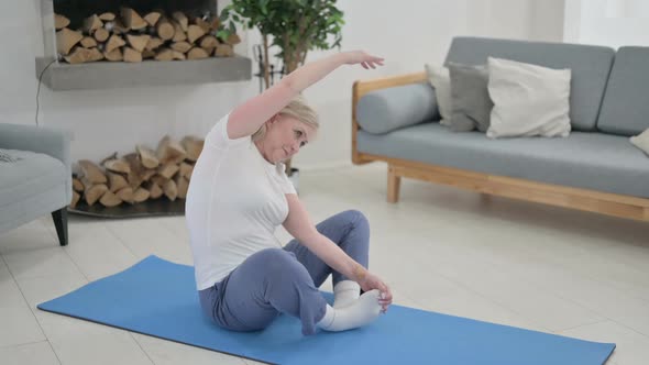 Old Woman Doing Yoga on Yoga Mat at Home alt
