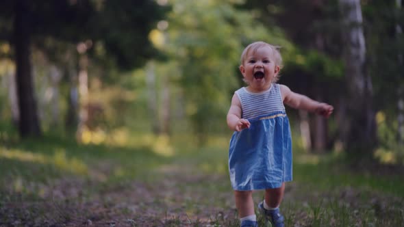 one year old baby learned to walk. little girl runs in the park alone alt