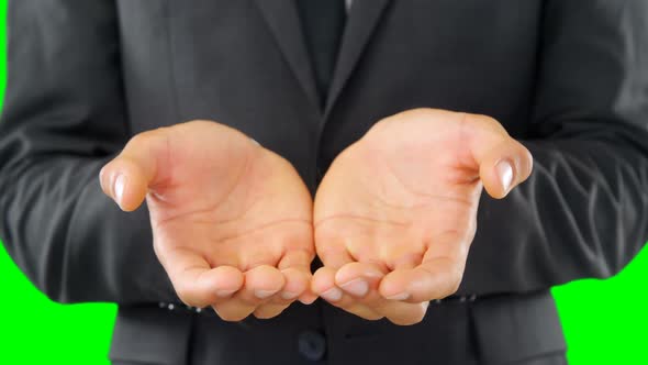 Businessman pretending to hold an invisible object alt