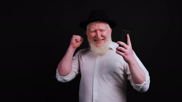 Close Up of an Excited Albino Man Isolated Look at Smartphone Get Good Message alt