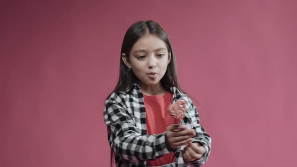 Little Girl is Happy with Heart Caramel on a Stick Surprised Emotion