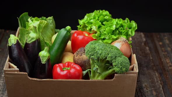 A Box Full of Fresh Vegetables on a Dark Background Wooden Vintage Table alt