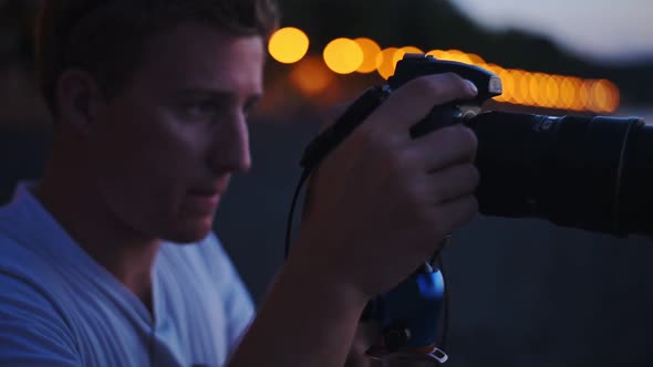 A Young Man Focusing Its Camera To Its Beautiful Subject In Italy At Night - Wide Shot alt