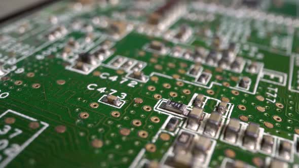 Extreme close-up of green Printed Circuit Board Electronics shot with dolly alt