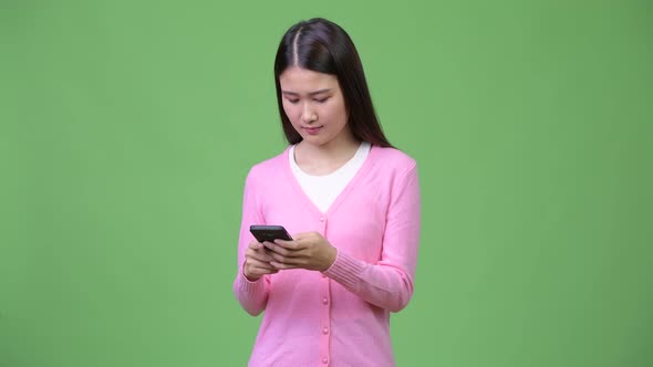 Young Beautiful Asian Woman Using Phone