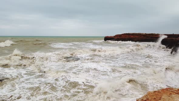 Big Waves Break on the Rocky Shore, White Foam on the Water alt