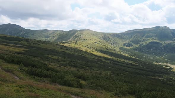 Landscape View of Green Hills in the Valley of Mountains with Coniferous Forests alt