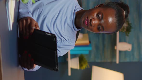 Vertical Video African American Businesswoman Taking Break Using Tablet alt