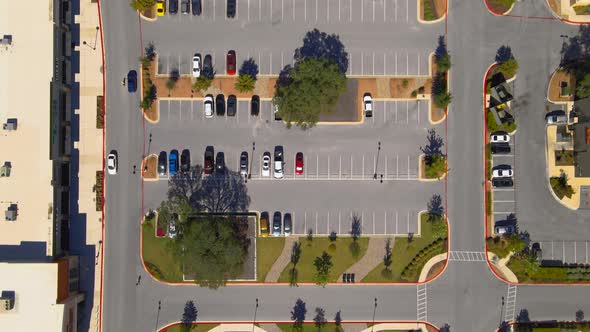 Aerial drone shot of shopping center parking area, drone 4K alt