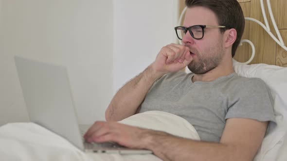 Beard Young Man Having Coughing on Laptop in Bed alt