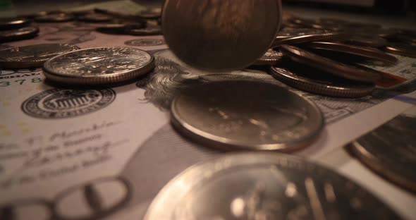 Silver Coins Falling on Dollar Bills Closeup  Movie Slow Motion