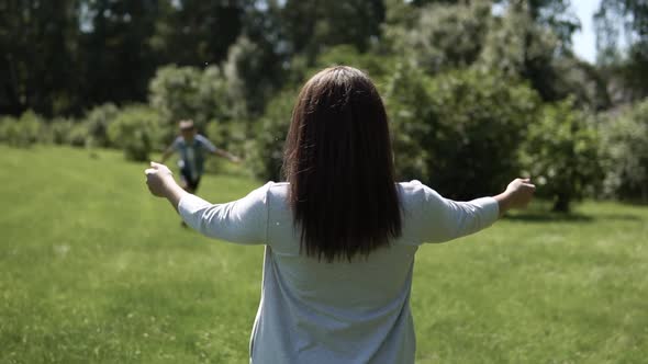 A Small Son Runs to His Mother in His Arms and Hugs Her alt