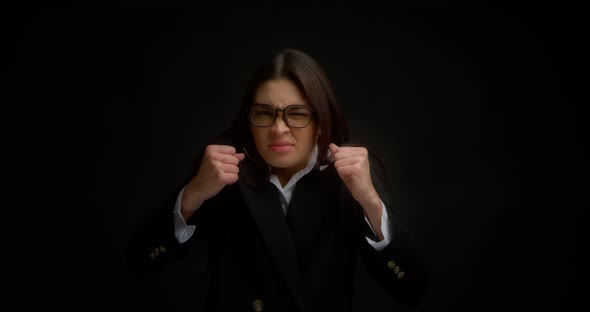 Woman with Glasses Shouting with an Aggressive Expression and Raised Hands