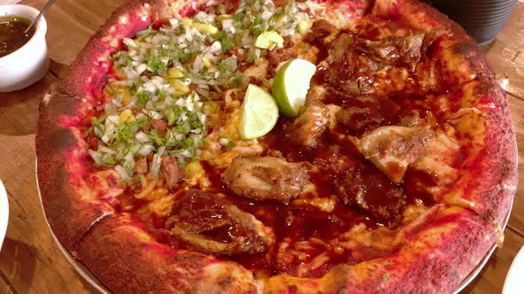 Tasty Vegan Pizza On Table Beside. Hand Held Circle Dolly alt