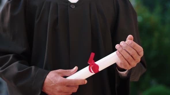 In the College Garden Graduate Guy Holding His