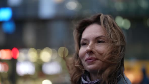 Charming Woman on City Street in Windy Day Closeup Portrait Shot Smiling Face alt