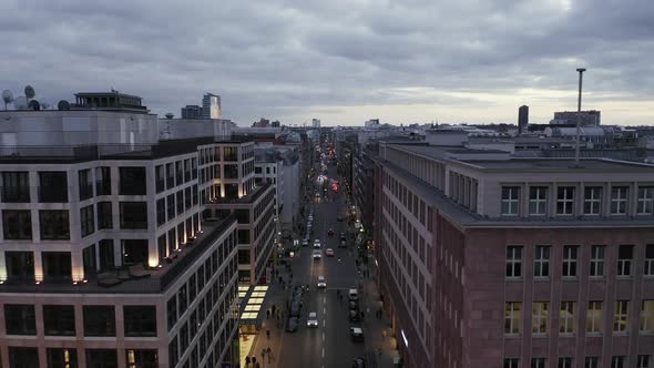 AERIAL: Low View Into Berlin Mitte Friedrichstrasse and Car Traffic City Lights, Subway Train alt