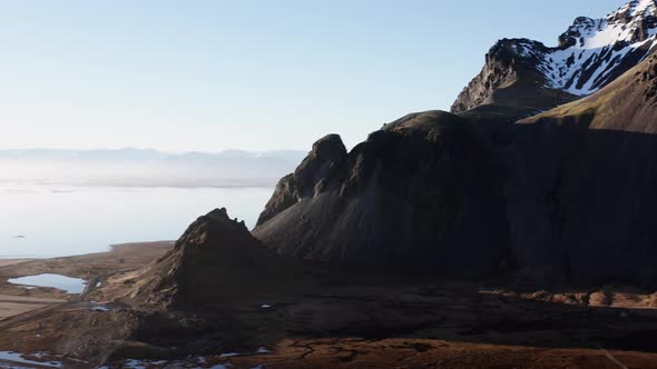 Drone Over Sunlit Coastline Mountain And Landscape alt