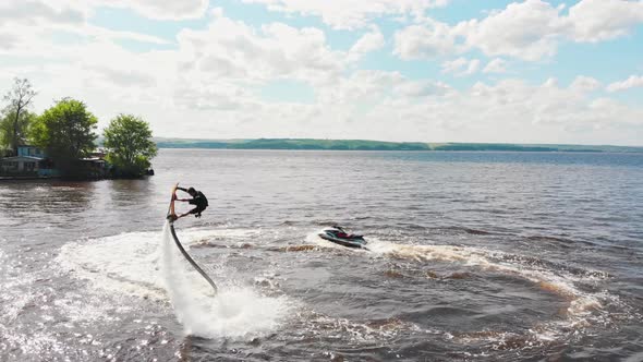 A Man Flying Over the Water  Aerial View alt