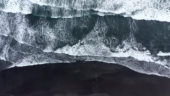 Flying Over Ocean Waves Rushing to the Shore in Iceland alt