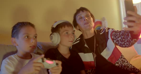 Woman Age Makes Photo Phone with Boys Playing Video Game While Being Distracted alt