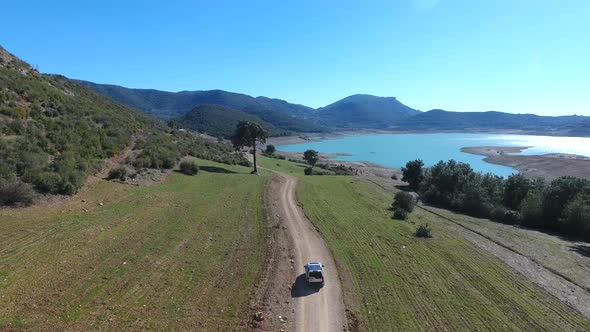 Vacation Car Driving Through the Wooded Road Towards the Sea alt