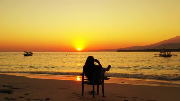 Female model posing on relaxing sea view beach vacation by blue sea with clean sandy background of t alt