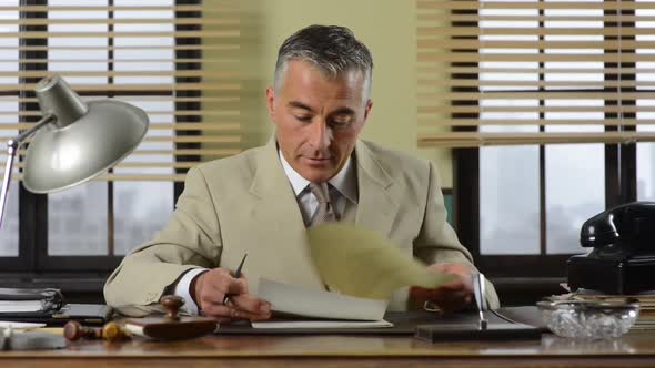Confident vintage businessman working at desk