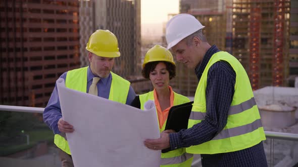 Three architects look over plans together