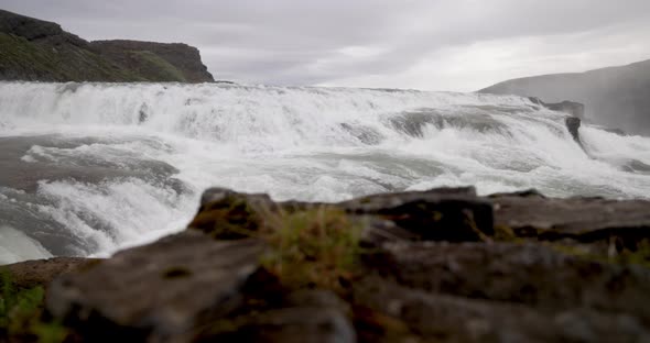 Guffoss Falls in Iceland with rocks with gimbal video in slow motion. alt