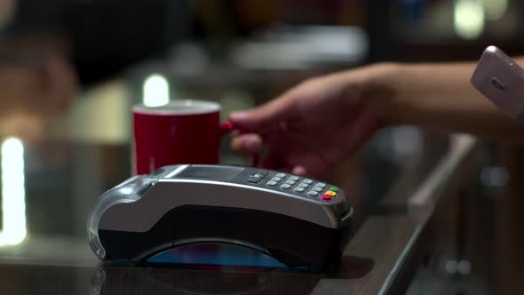 Customer using smartphone to payment with credit transaction in café