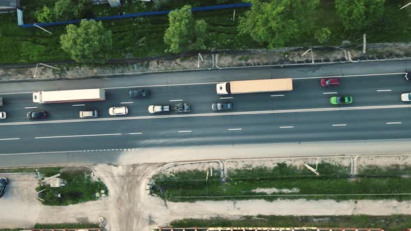 Aerial View of a Country Road with Cars Approaching the Traffic Jam alt