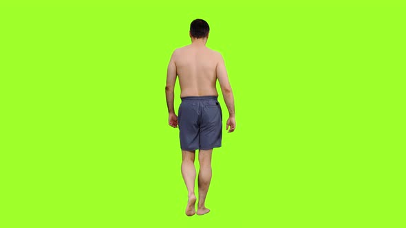 Rear View of Shirtless Adult Man Walking in Shorts