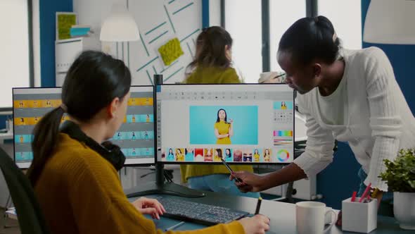 Diverse Photo Editors Sitting in Creative Workplace Retouching Photos alt