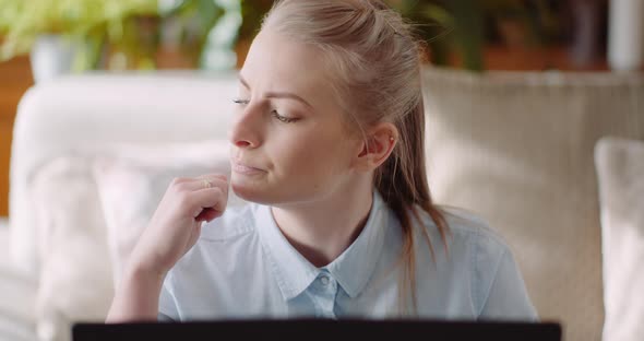 Woman Working on Computer Thinking and Solving Problem alt