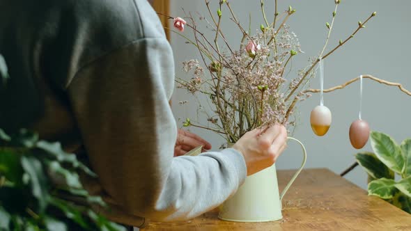 Woman Making DIY Easter Decoration for Home Interior alt