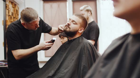 Barber Smoothes the Hair on the Man's Neck Beard Cutting alt