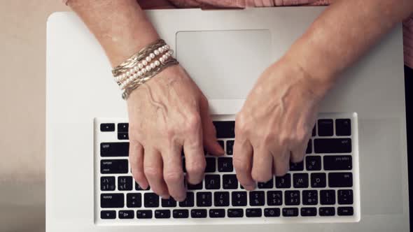 Senior Woman Hands Typing On Laptop Keyboard. Elderly Hands Typing On Notebook Keyboard. alt