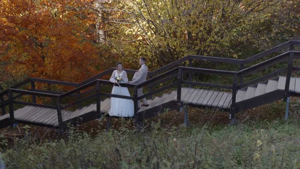 Stylish and Tender Couple in Love  the Bride and Groom  Meets Each Other on Stairs alt