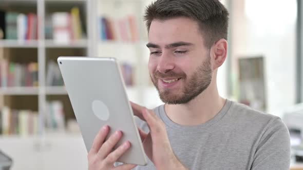 Portrait of Attractive Young Man Using Digital Tablet alt
