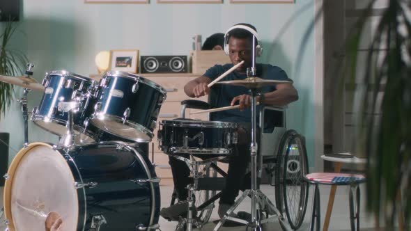 Black Man on Wheelchair Playing Drums alt