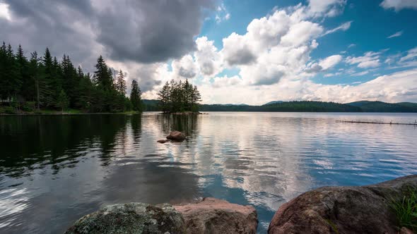 Summer view of а mountain lake and moving fluffy clouds  alt
