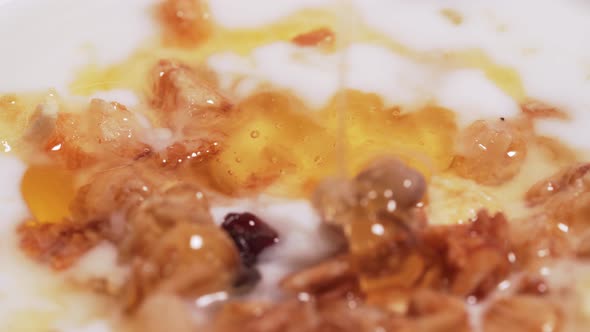 Macro Shot - Drop of Mountain Honey for Granola and Yogurt. The Concept of a Healthy Diet, Fitness alt